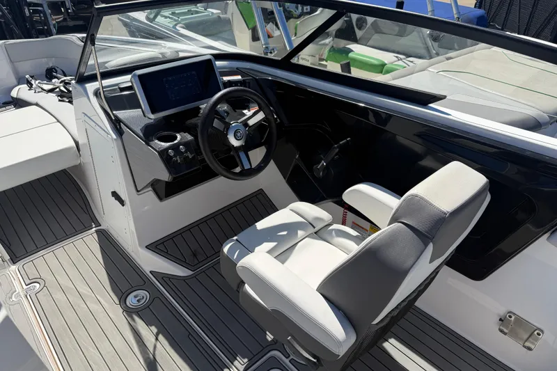 Slide: The Image of 2023 Yamaha Boats AR250 cockpit with steering wheel and modern dashboard. - 27