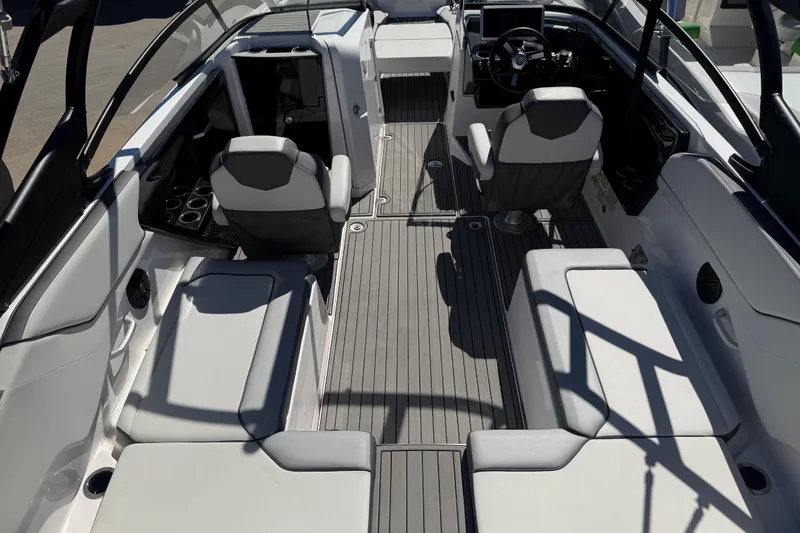 Slide: The Image of 2023 Yamaha Boats AR250 interior with sleek seating and modern dashboard design. - 32