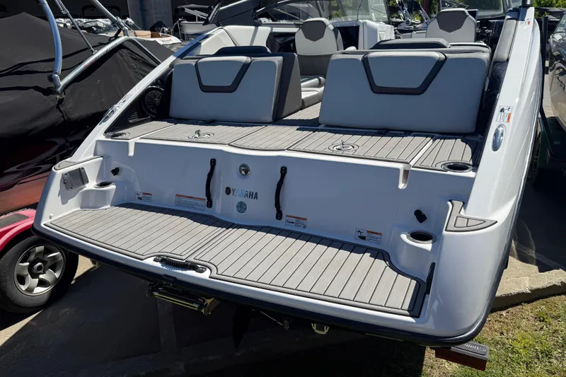 Slide: The Image of 2023 Yamaha Boats AR250 rear view, showcasing sleek design and spacious seating. - 34