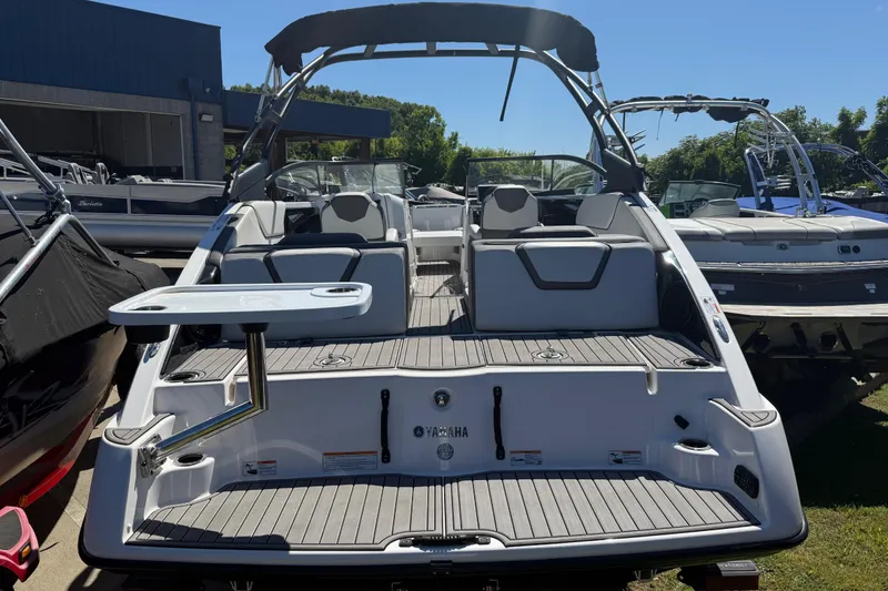Slide: The Image of 2023 Yamaha Boats AR250, sleek design, spacious seating, and modern features, docked outdoors. - 36