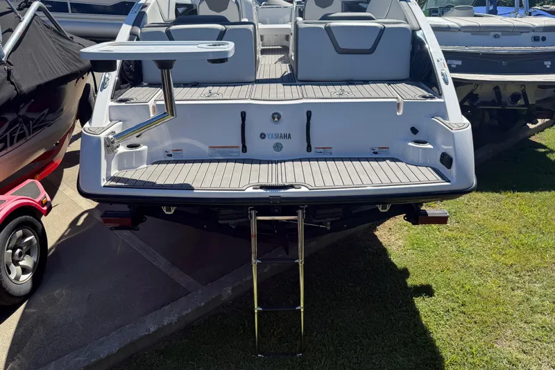 Slide: The Image of 2023 Yamaha Boats AR250 rear view with swim platform and ladder. - 37