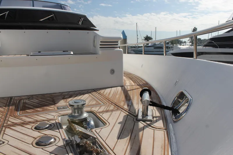 Slide: The Image of Deck view of 1999 Horizon 70 Motor Yacht with polished wood and metal fittings. - 10
