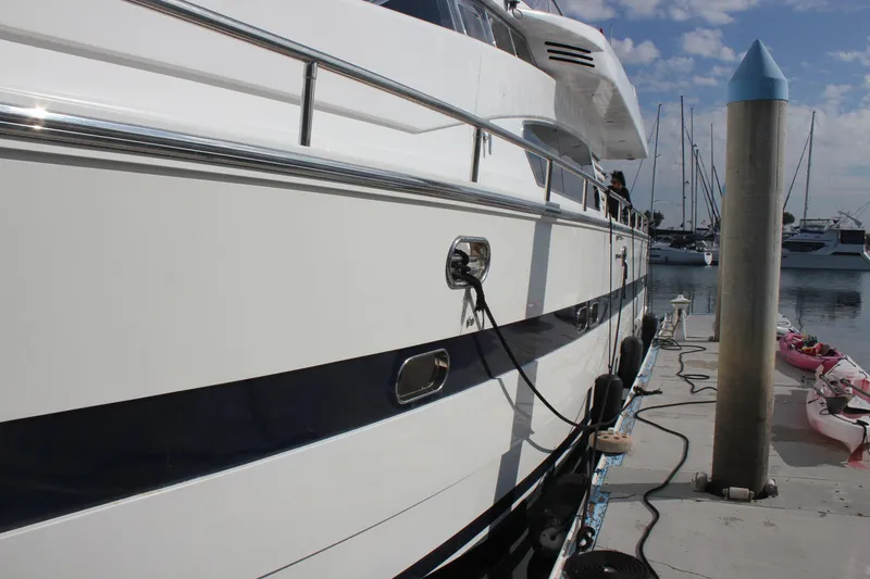 Slide: The Image of 1999 Horizon 70 Motor Yacht docked at marina with clear sky. - 11
