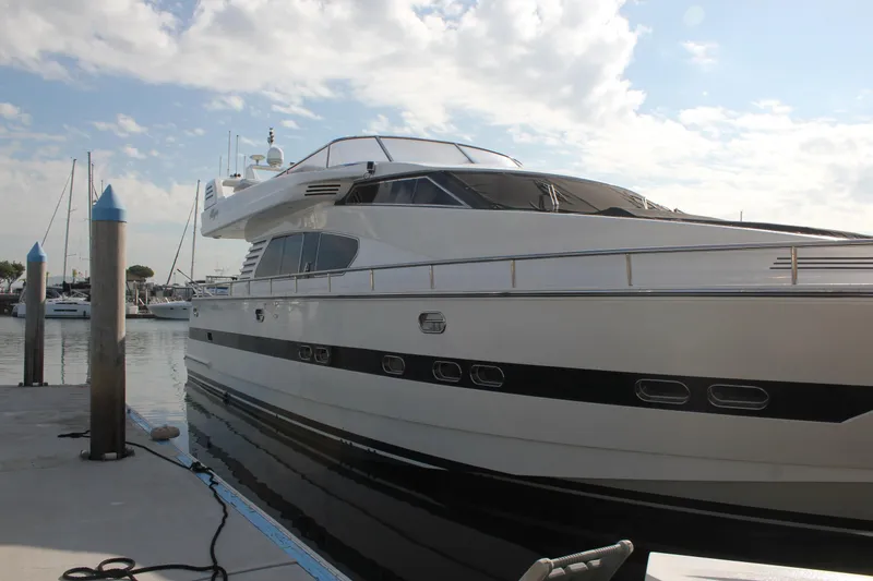 Slide: The Image of 1999 Horizon 70 Motor Yacht docked at marina under a partly cloudy sky. - 14