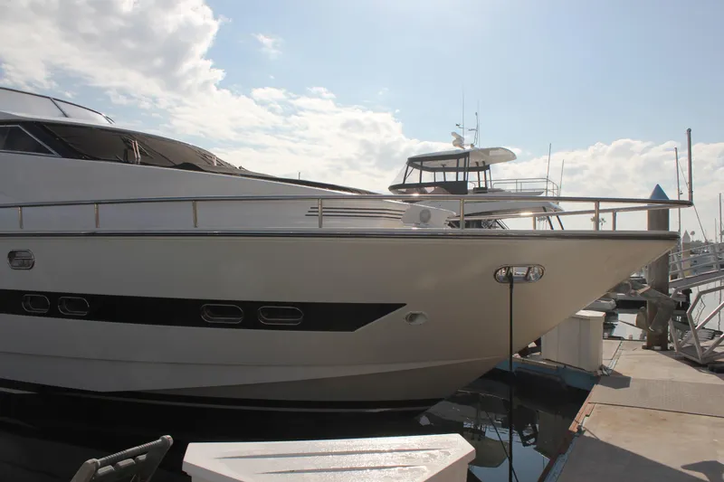 Slide: The Image of 1999 Horizon 70 Motor Yacht docked at marina under a partly cloudy sky. - 15