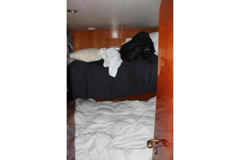 Slide: The Image of Interior cabin of 1999 Horizon 70 Motor Yacht with unmade beds. - 17