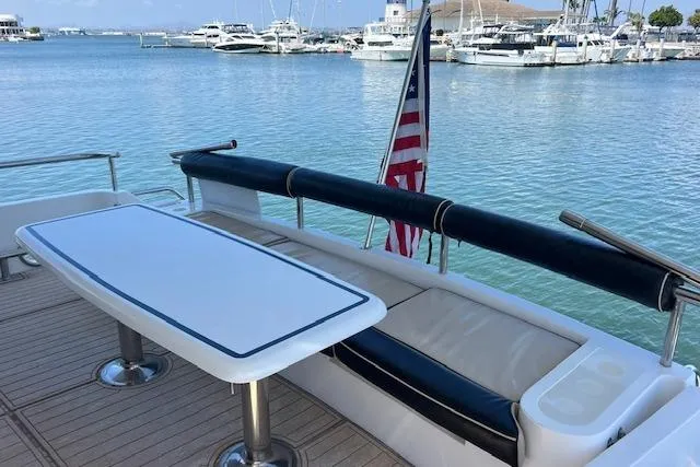 Slide: The Image of Aft deck of 1999 Horizon 70 Motor Yacht with seating and table, overlooking marina. - 5