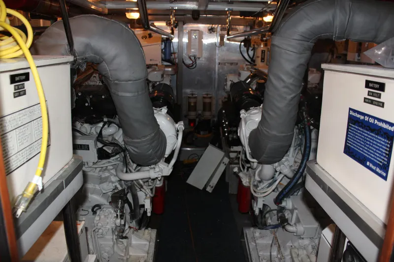 Slide: The Image of Engine room of a 1999 Horizon 70 Motor Yacht, featuring dual engines and equipment. - 19