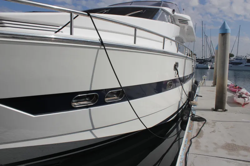 Slide: The Image of 1999 Horizon 70 Motor Yacht docked at marina, side view. - 2