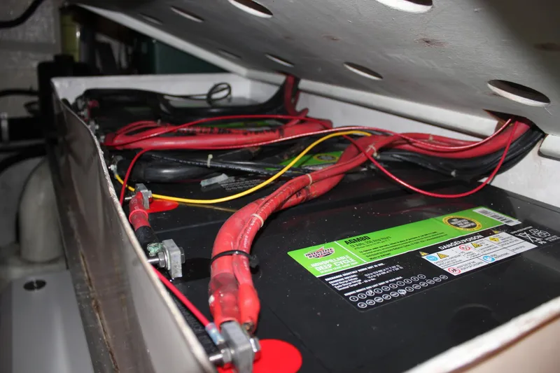 Slide: The Image of Battery compartment of a 1999 Horizon 70 Motor Yacht with visible wiring. - 23