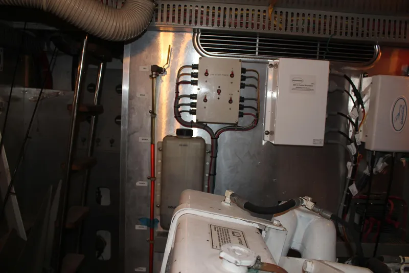 Slide: The Image of Engine room of a 1999 Horizon 70 Motor Yacht with control panels and equipment. - 29