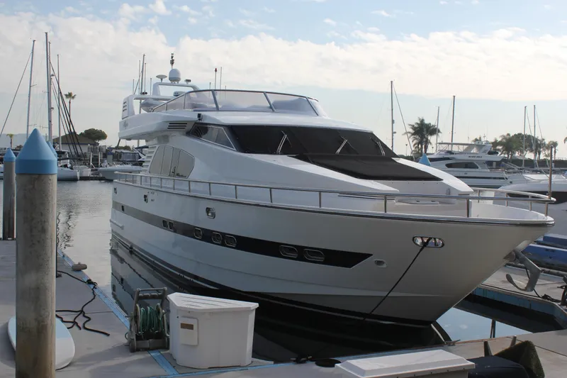 Slide: The Image of 1999 Horizon 70 Motor Yacht docked at marina, surrounded by other boats. - 4