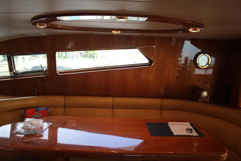 Slide: The Image of Luxurious interior of 1999 Horizon 70 Motor Yacht with wooden table and leather seating. - 40