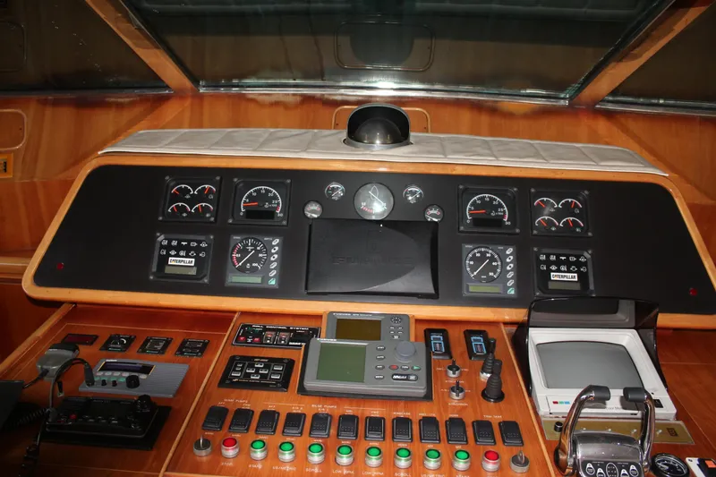 Slide: The Image of Cockpit of 1999 Horizon 70 Motor Yacht with control panels and navigation instruments. - 44