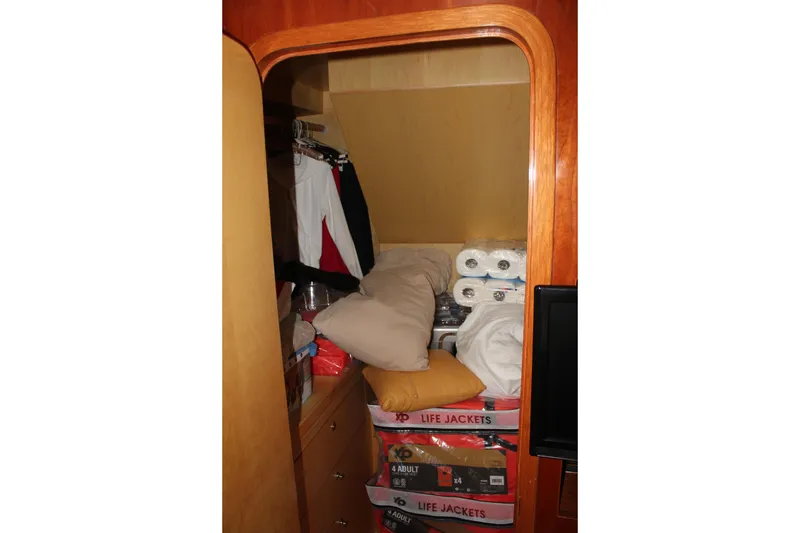 Slide: The Image of Storage area in 1999 Horizon 70 Motor Yacht with life jackets and supplies. - 50