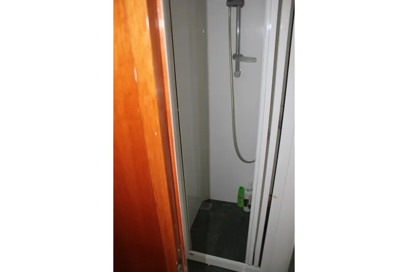 Slide: The Image of Shower area in 1999 Horizon 70 Motor Yacht with wooden door and modern fixtures. - 56