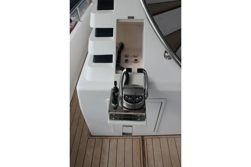 Slide: The Image of Control panel of a 1999 Horizon 70 Motor Yacht with wooden deck flooring. - 61