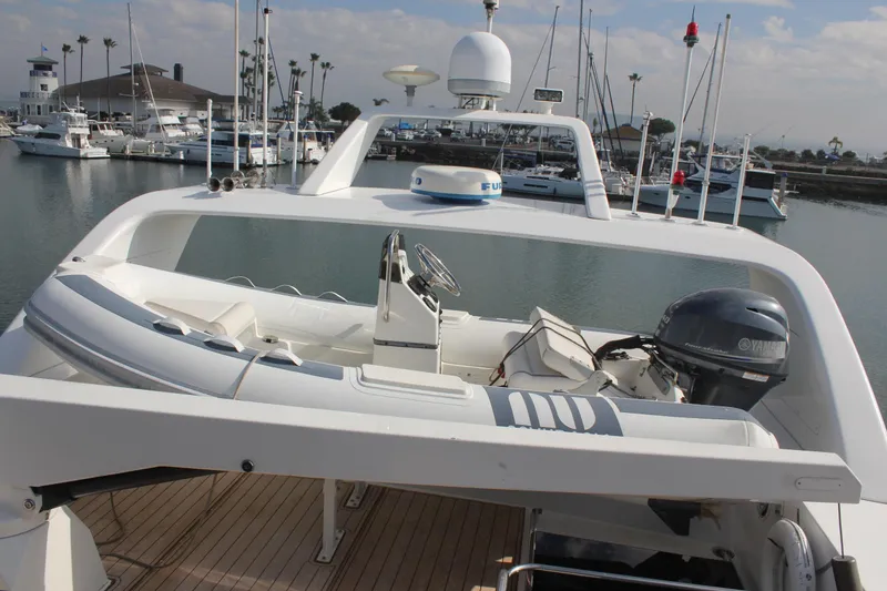Slide: The Image of 1999 Horizon 70 Motor Yacht with dinghy on deck, docked in marina. - 63