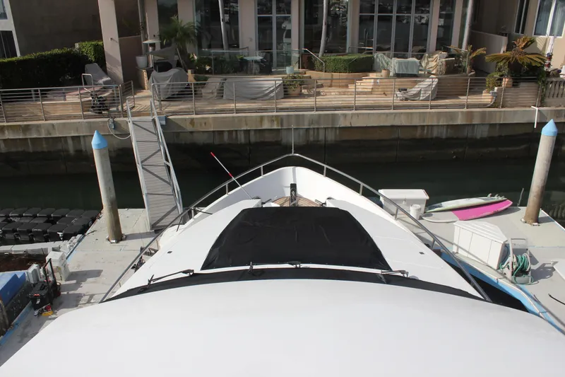 Slide: The Image of Bow view of 1999 Horizon 70 Motor Yacht docked at marina. - 64