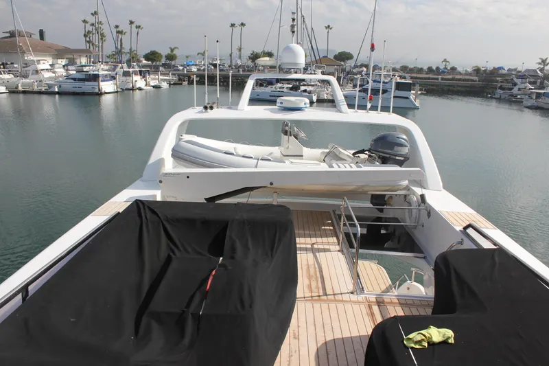 Slide: The Image of 1999 Horizon 70 Motor Yacht docked in marina, featuring spacious deck and covered seating. - 65