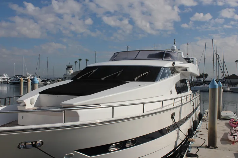 Slide: The Image of 1999 Horizon 70 Motor Yacht docked at marina under blue sky. - 7