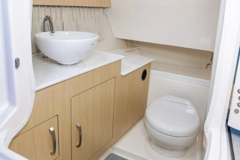 Slide: The Image of Manufacturer Provided Image: 2026 Regal 33 OBX boat bathroom with modern sink and toilet. - 10