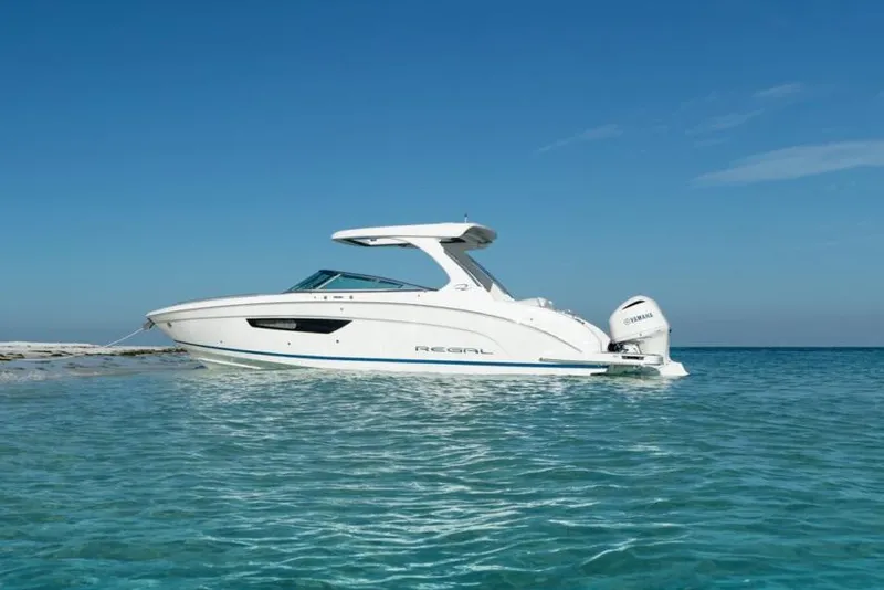 Slide: The Image of Manufacturer Provided Image: 2026 Regal 33 OBX boat on clear blue water under a sunny sky. - 3