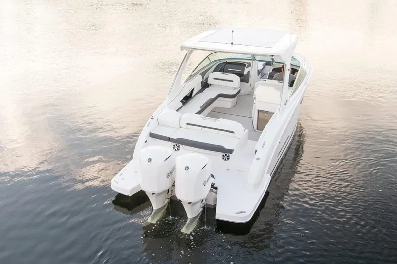 Slide: The Image of Manufacturer Provided Image: 2026 Regal 33 OBX boat with dual outboard engines on calm water. - 4