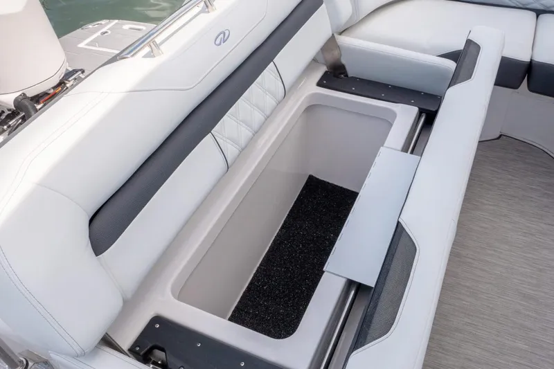 Slide: The Image of Manufacturer Provided Image: 2026 Regal 33 OBX boat seat with open storage compartment, featuring sleek white upholstery. - 8