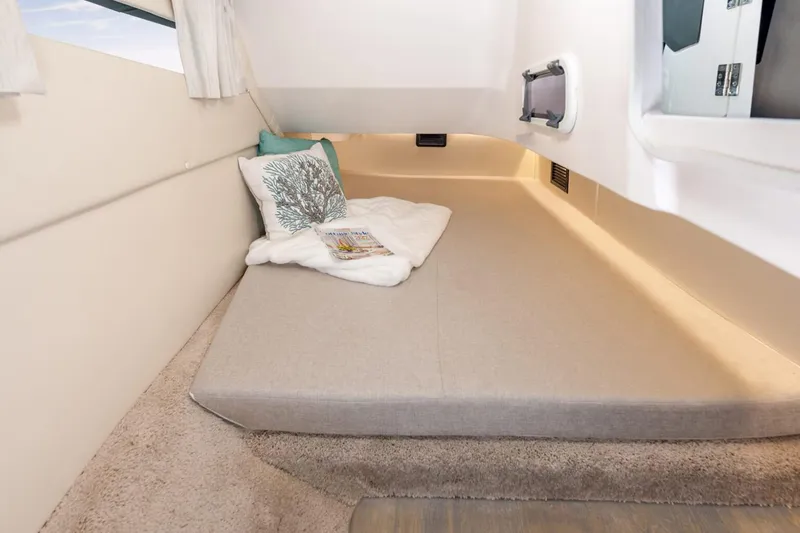 Slide: The Image of Manufacturer Provided Image: 2026 Regal 33 OBX cabin interior with cozy bed and decorative pillows. - 9
