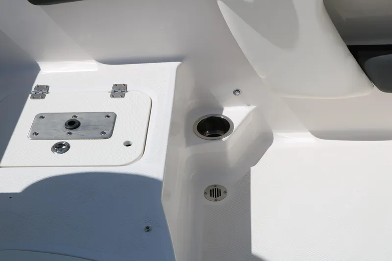 Slide: The Image of 2025 Chaparral 21 SSi Ski & Fish boat interior detail, featuring storage and cup holder. - 44
