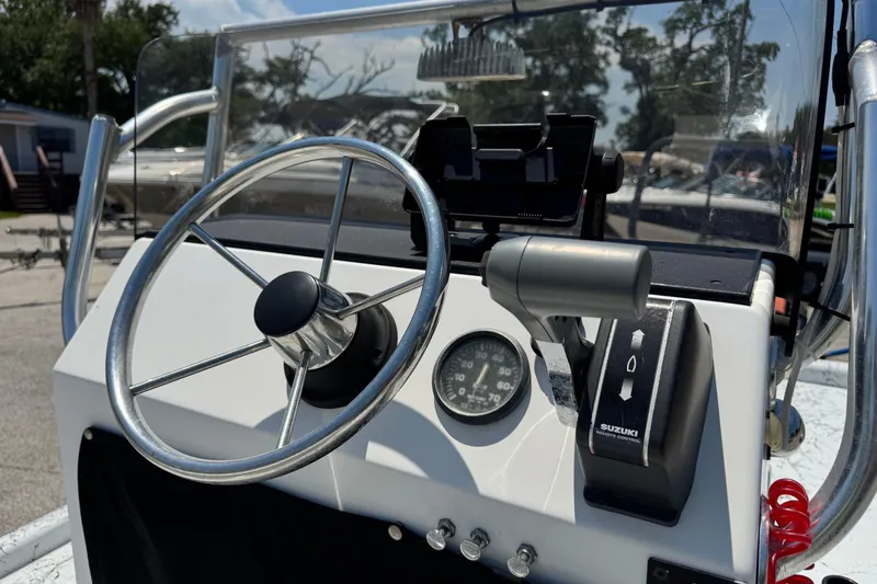 Slide: The Image of Steering console of a 2014 Mowdy 13 Scooter boat with Suzuki controls. - 10
