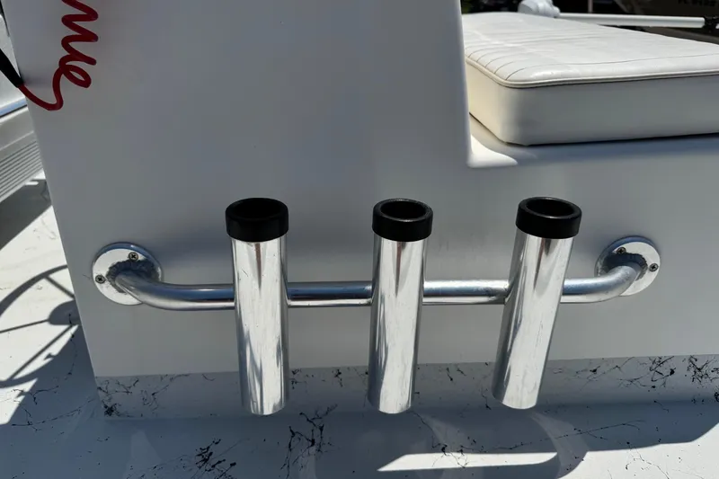 Slide: The Image of Rod holders on a 2014 Mowdy 13 Scooter boat, featuring white seating. - 11
