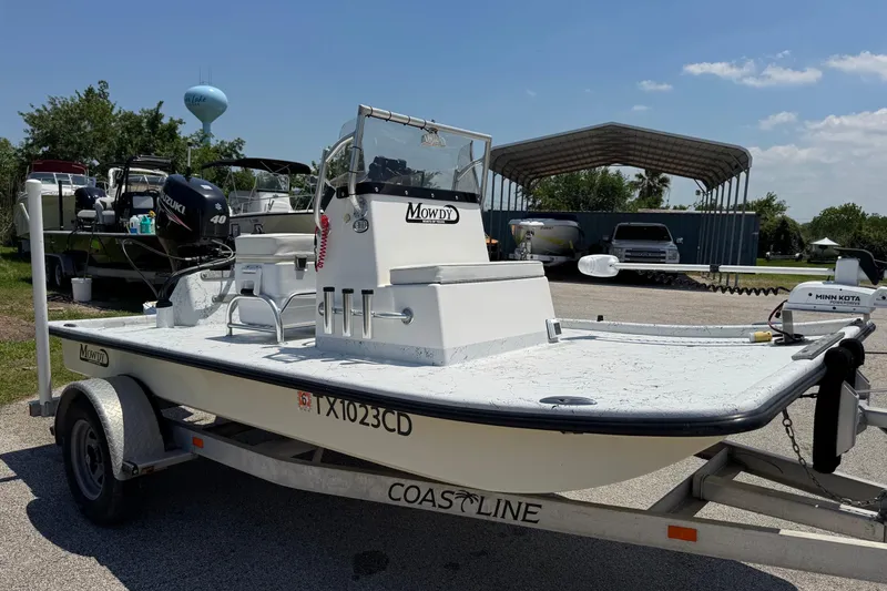 Slide: The Image of 2014 Mowdy 13 Scooter boat on trailer, parked outdoors under clear sky. - 12