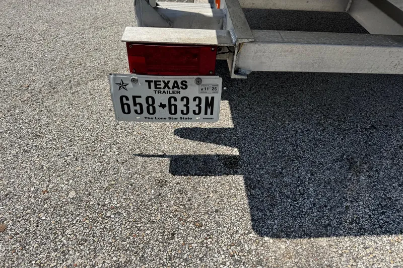 Slide: The Image of Trailer with Texas license plate on gravel, Mowdy 13 Scooter, 2014 model. - 5