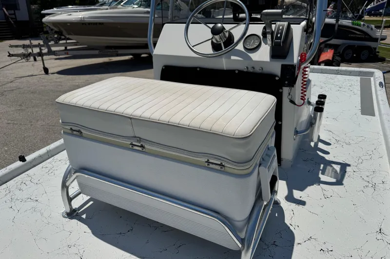 Slide: The Image of 2014 Mowdy 13 Scooter boat interior with steering console and cushioned seat. - 8