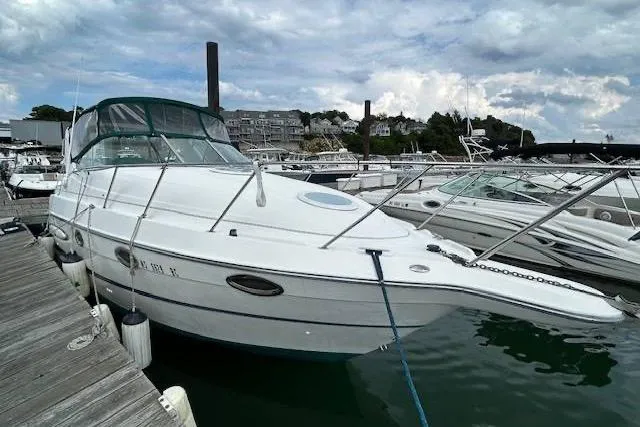 The Image of 2003 Maxum 2900 SCR boat docked at marina under cloudy sky. - 0