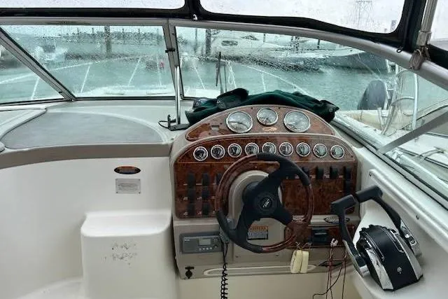 Slide: The Image of 2003 Maxum 2900 SCR boat cockpit with steering wheel and control panel. - 3