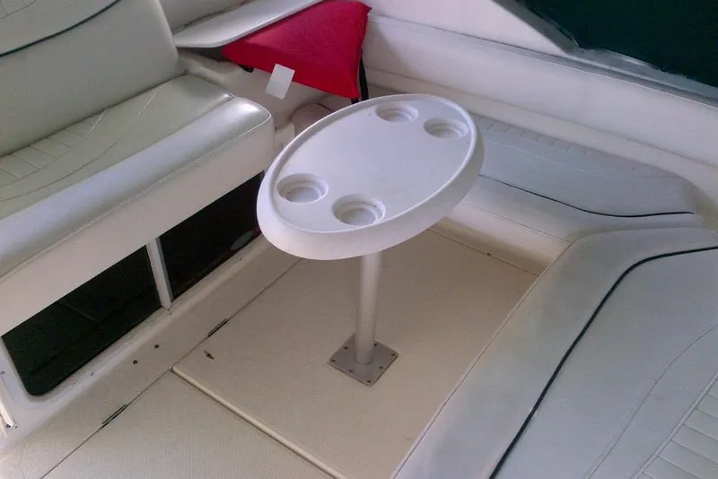 Slide: The Image of 2003 Maxum 2900 SCR boat interior with white seating and a round table. - 5