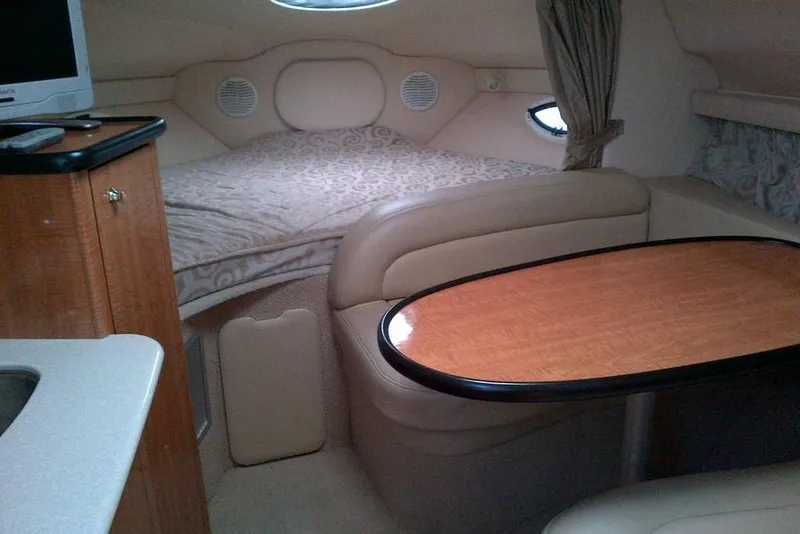 Slide: The Image of Interior of 2003 Maxum 2900 SCR boat with cozy seating and sleeping area. - 8