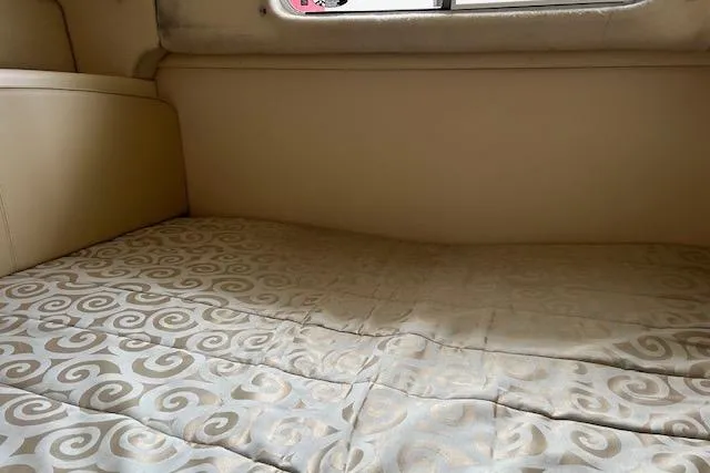 Slide: The Image of Interior cabin bed of 2003 Maxum 2900 SCR boat with patterned bedding. - 9