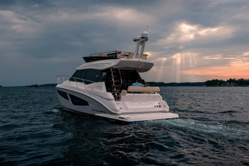 Slide: The Image of Manufacturer Provided Image: 2026 Regal 42 Fly yacht cruising on open water at sunset. - 3