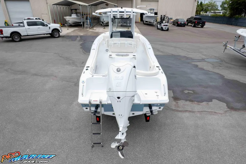 Slide: The Image of 2026 Sea Hunt Ultra 245 SE boat with Yamaha engine in a marina setting. - 11