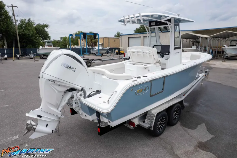 Slide: The Image of 2026 Sea Hunt Ultra 245 SE boat with Yamaha engine on trailer in marina. - 13