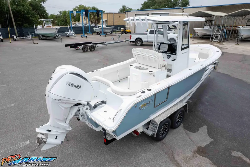 Slide: The Image of 2026 Sea Hunt Ultra 245 SE boat on trailer with Yamaha engine in marina setting. - 14