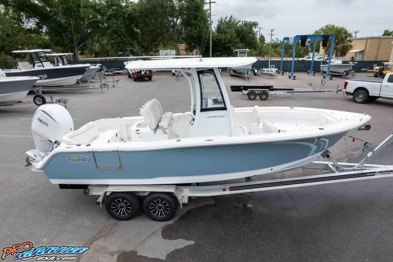 Slide: The Image of 2026 Sea Hunt Ultra 245 SE boat on trailer, parked in a marina lot. - 16