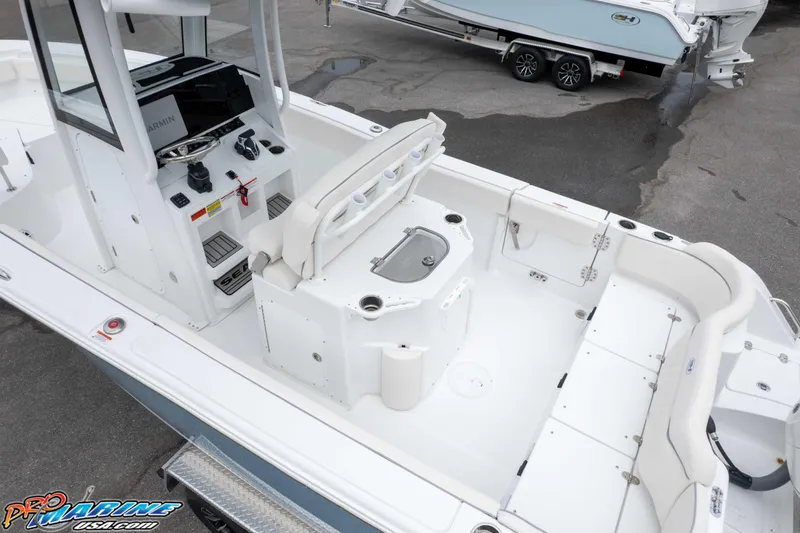 Slide: The Image of 2026 Sea Hunt Ultra 245 SE boat interior with helm and seating area. - 19