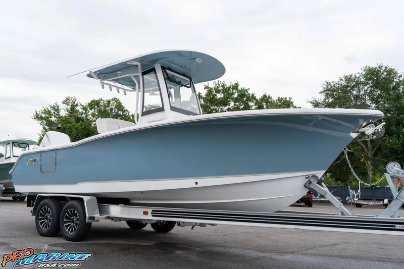 Slide: The Image of 2026 Sea Hunt Ultra 245 SE boat on trailer, displayed outdoors. - 21