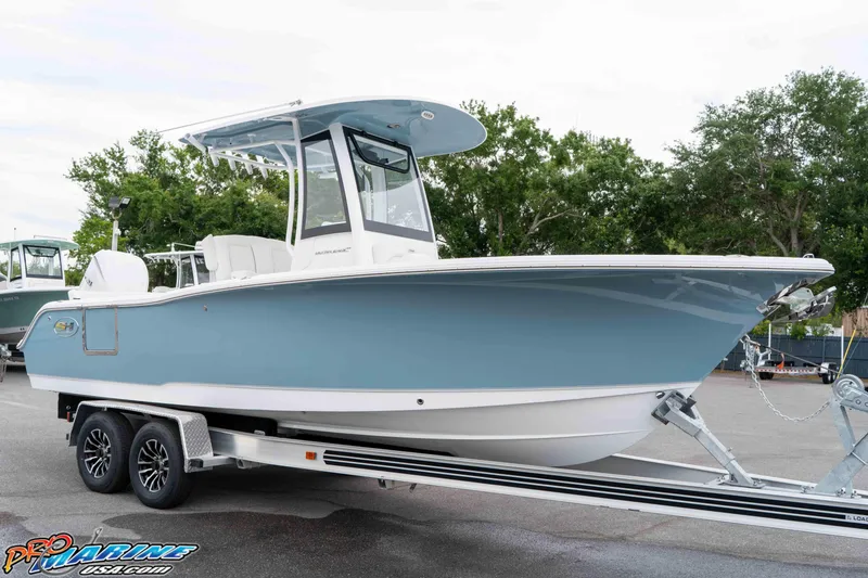 Slide: The Image of 2026 Sea Hunt Ultra 245 SE boat on trailer, parked outdoors. - 22