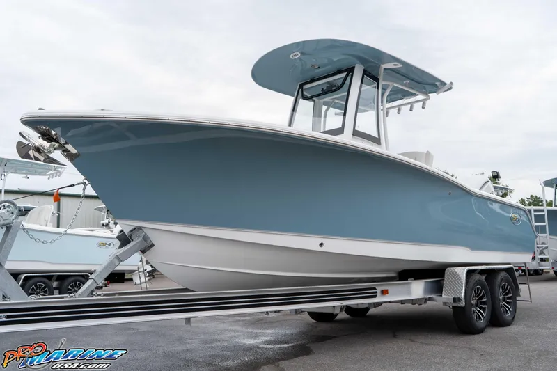 Slide: The Image of 2026 Sea Hunt Ultra 245 SE boat on trailer, displayed outdoors. - 25